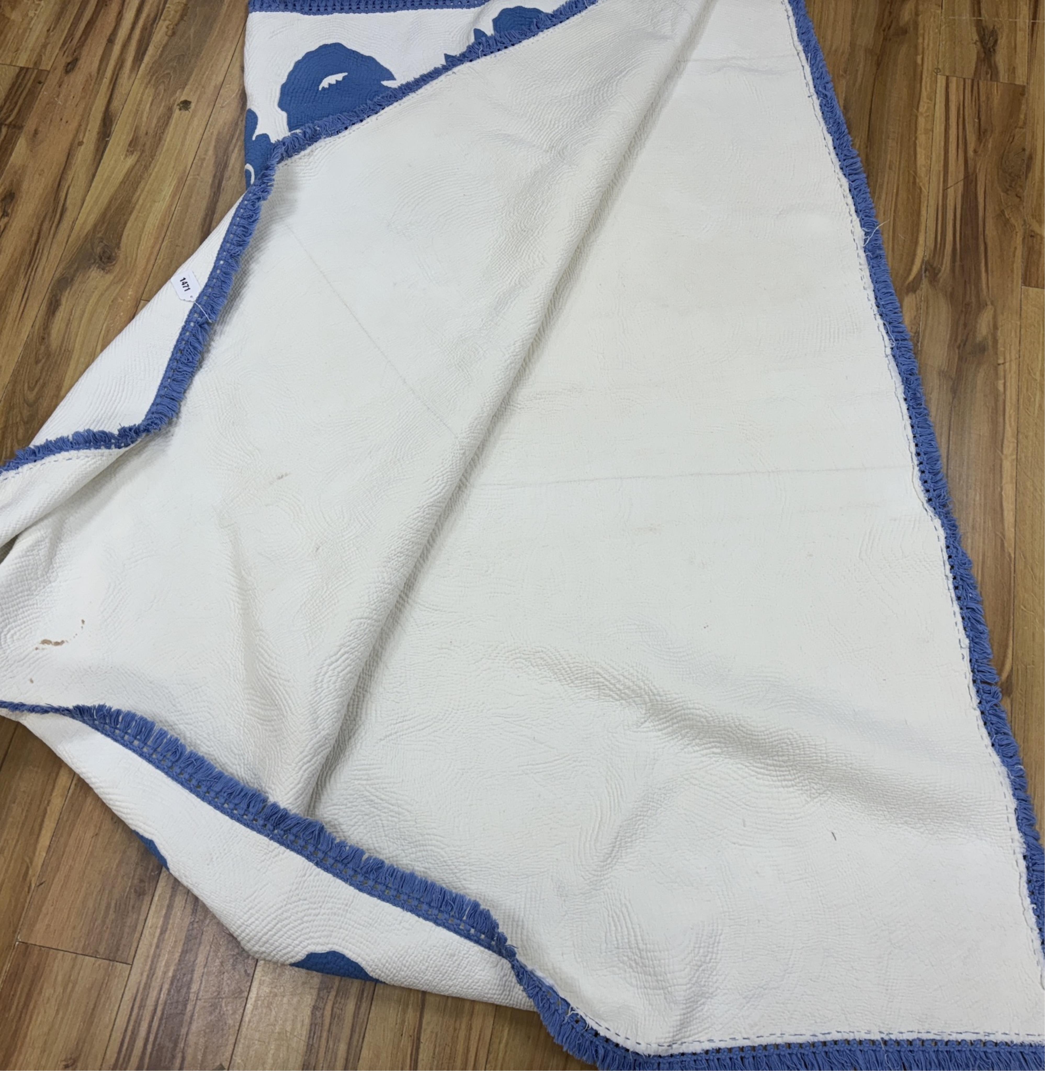 An American blue and white fringed bedcover (quilt)